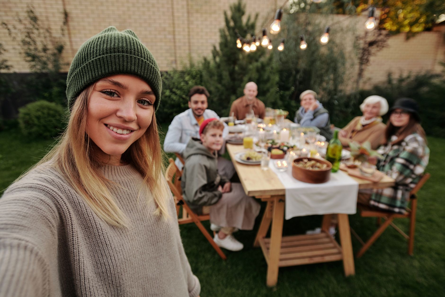 Friends sharing a meal at a long outdoor table